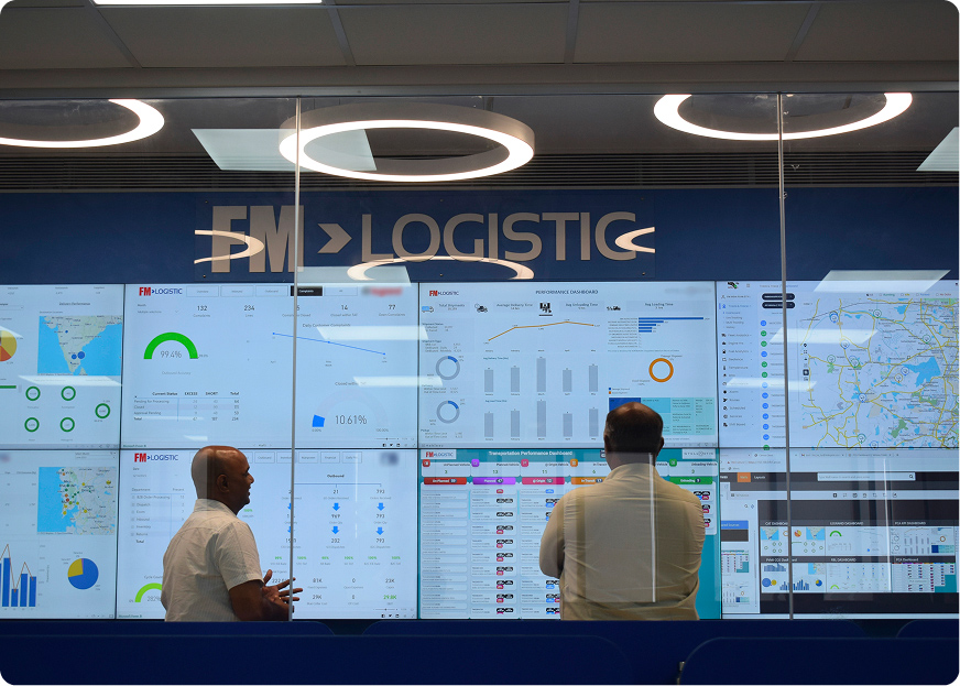 Logistics control tower displaying real-time supply chain dashboards in a central operations control room at FM Logistic.